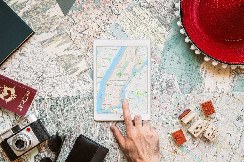 Map Guides Ttweakmaps by TravelTweaks shown with a tablet map, paper maps, passport, camera, and travel items for simple route planning.