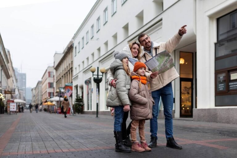Family with two children standing on a Paris street, holding a map and planning Things to Do With Kids in Paris.
