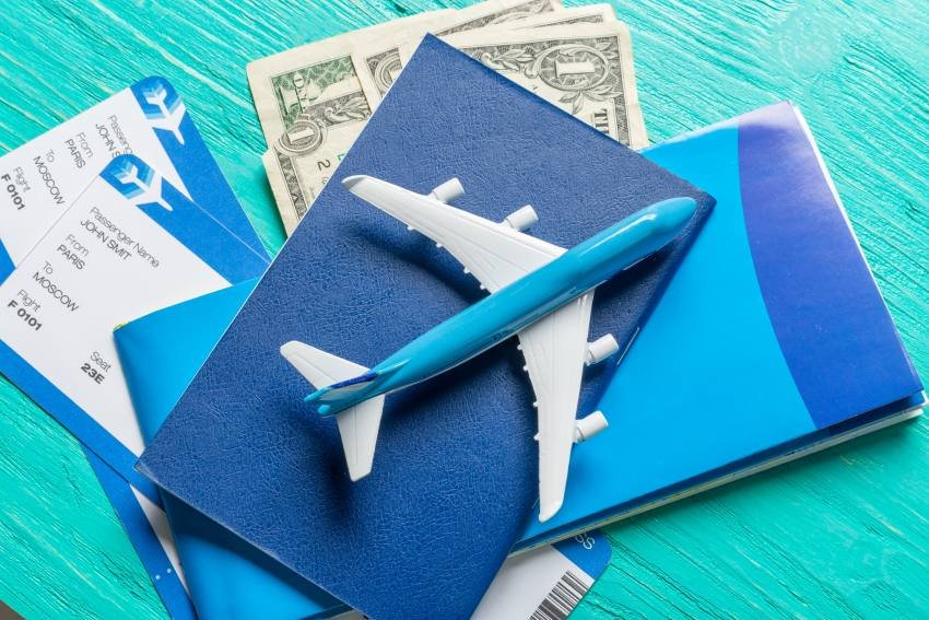 Travel documents, flight ticket, cash, and airplane model showing TTweakFlight Offers and flight savings.