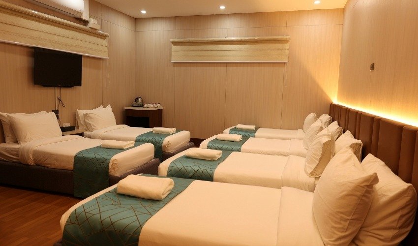 Hotel Room Bed Setup for Families Hotel room with several beds showing a sleeping setup for families or groups